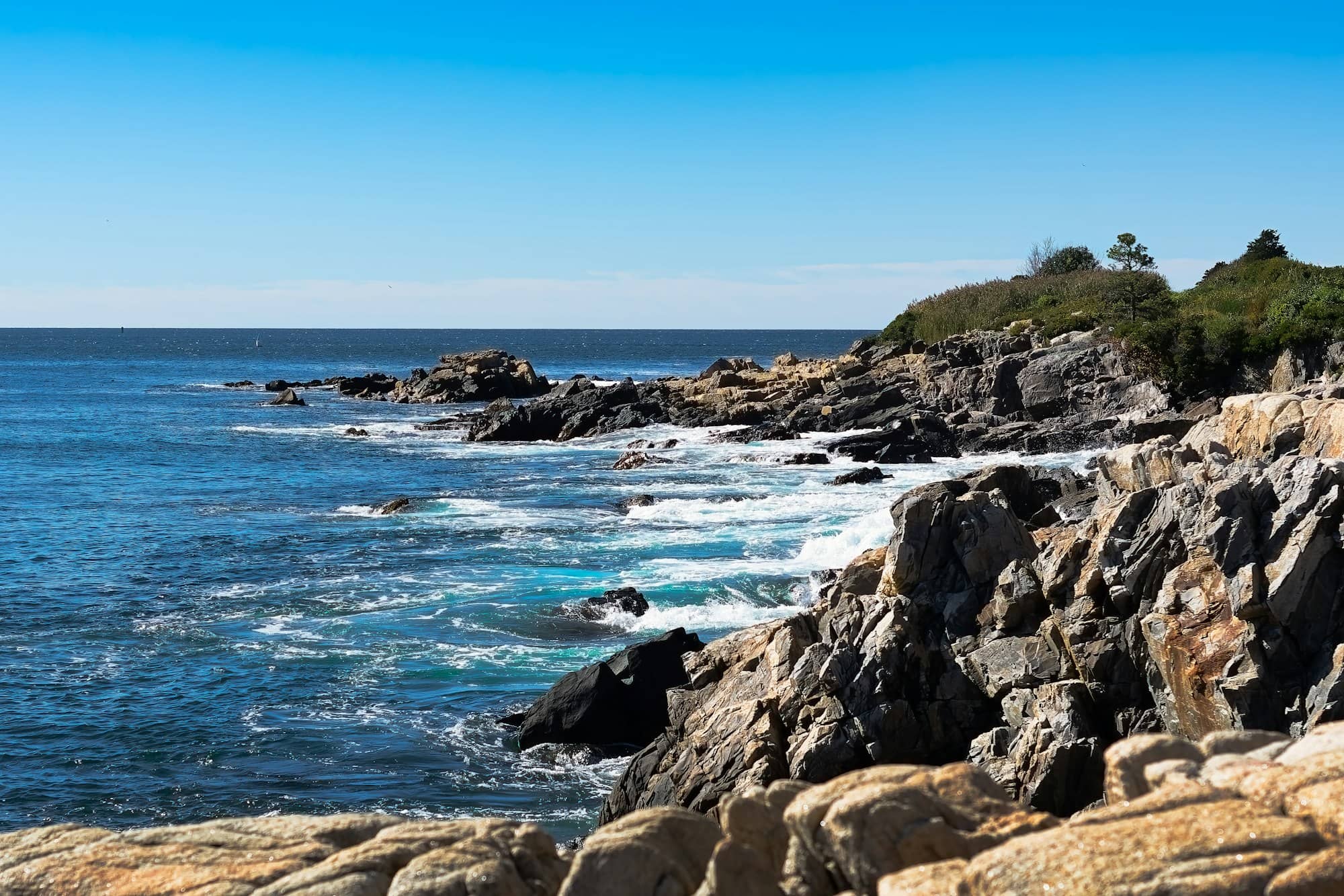a view of a rocky shore with a body of water