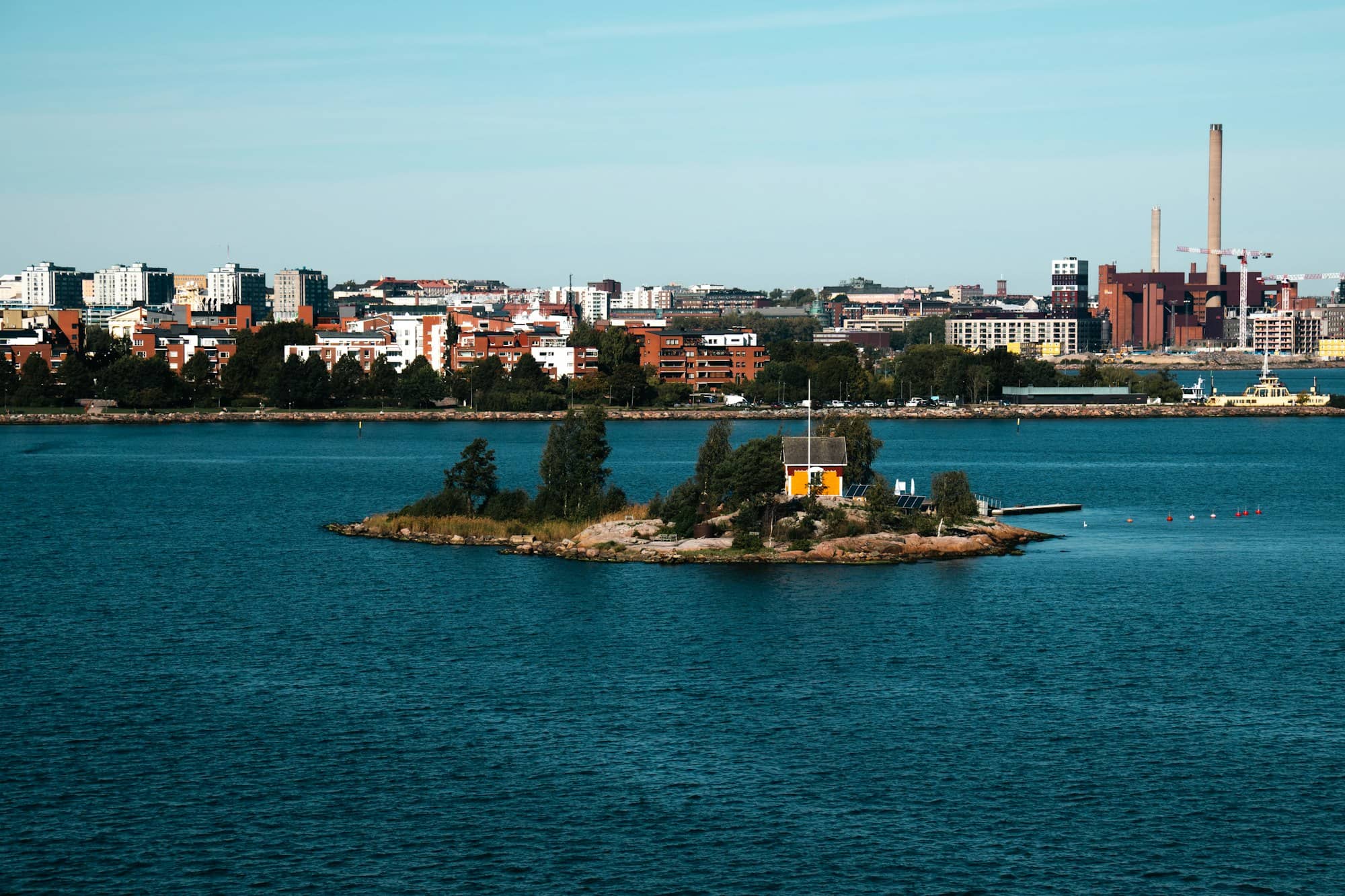 A small island in the middle of a large body of water