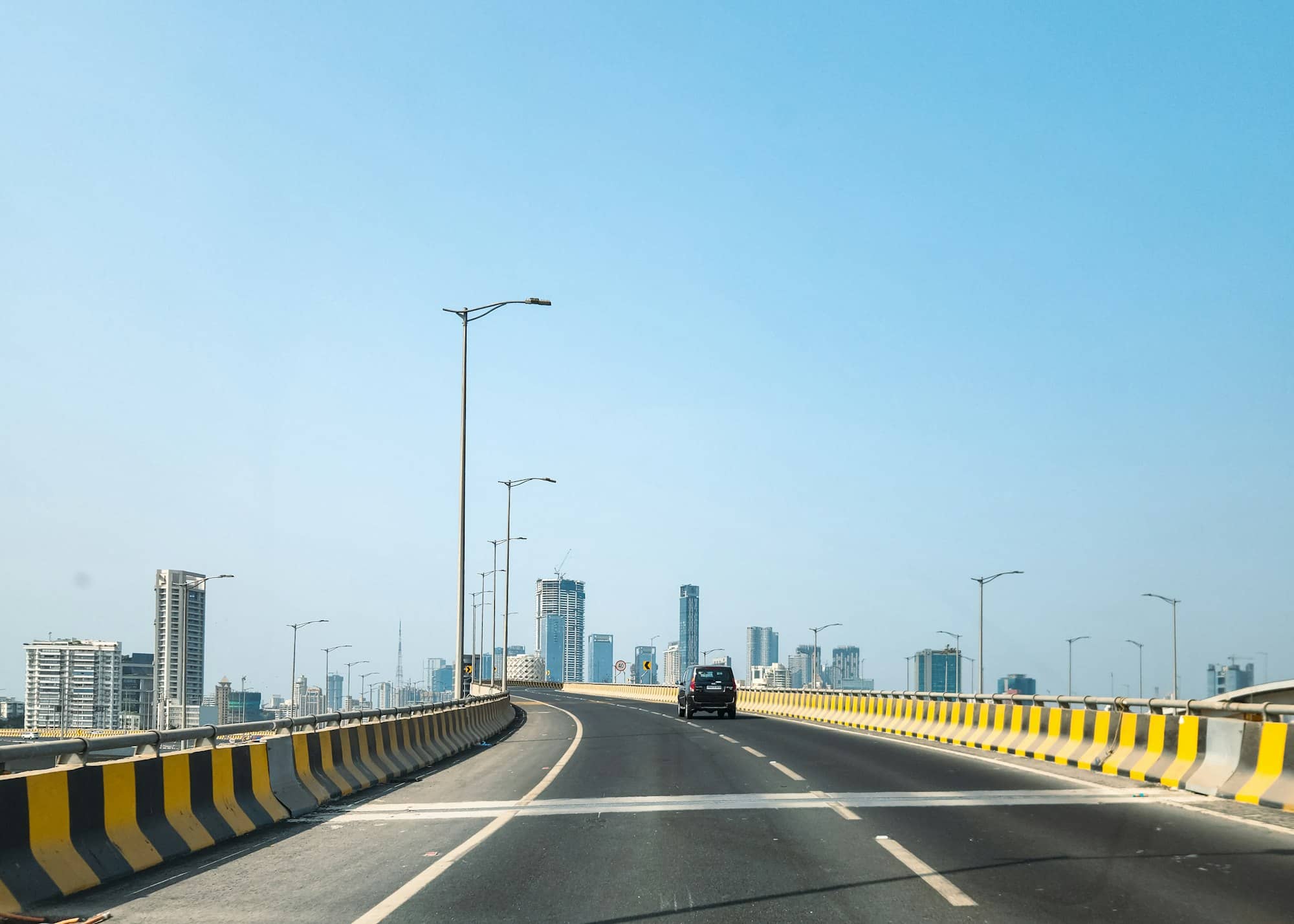 A road leads to buildings in the distance.
