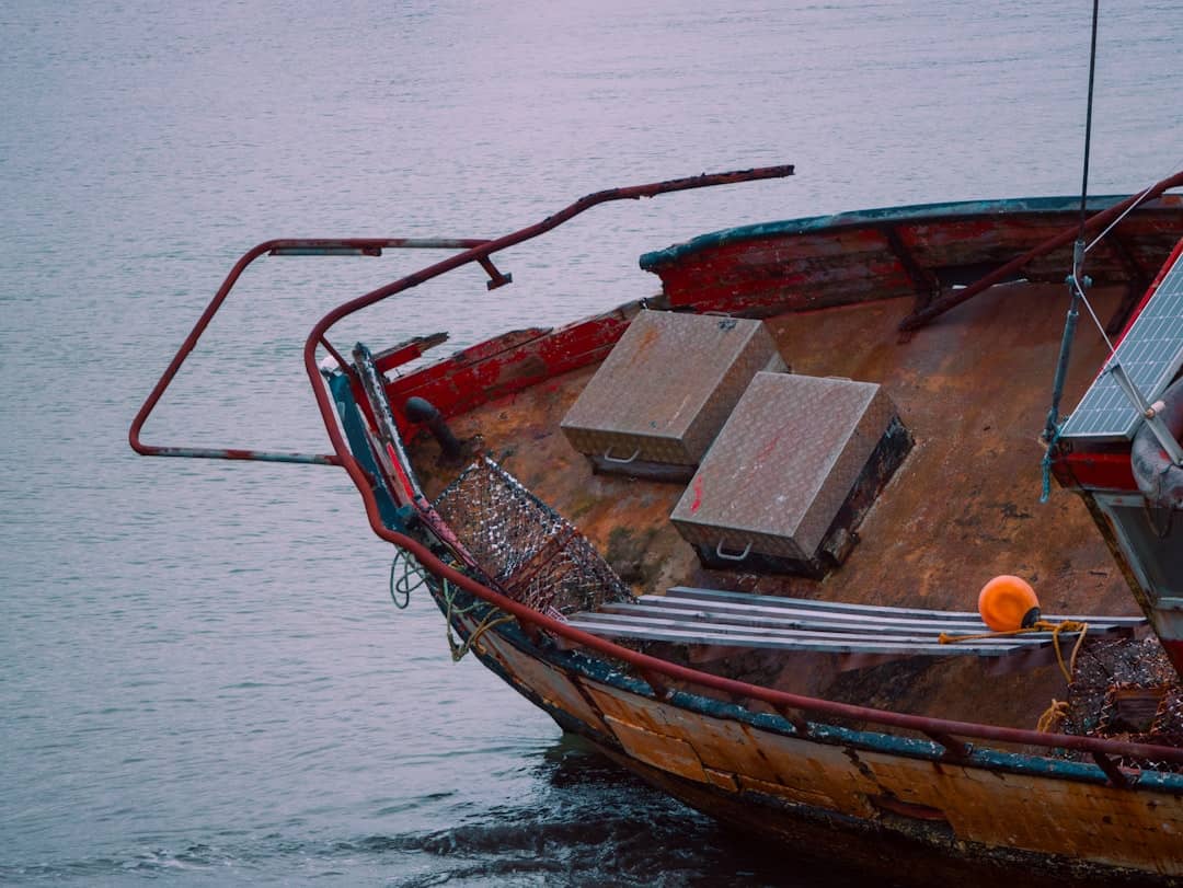 An old, rusty boat sits near the water.