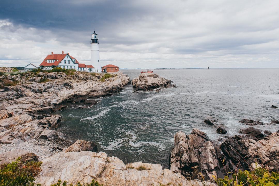 a light house sitting on top of a cliff next to the ocean