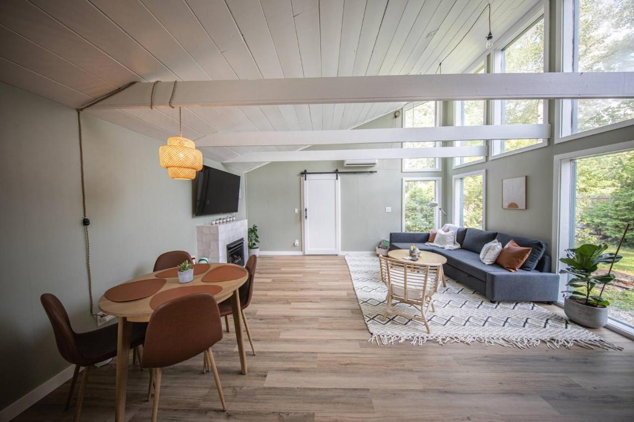 a living room with a blue couch and a table at Unwind at this Modern Bethel Village Escape in Bethel