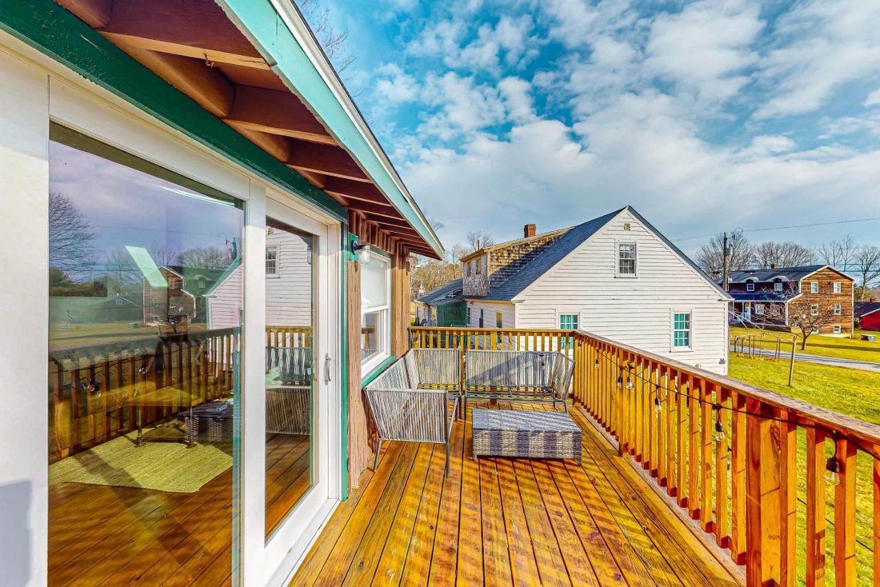 a balcony with a view of a house at Bay Cabin in Boothbay Harbor
