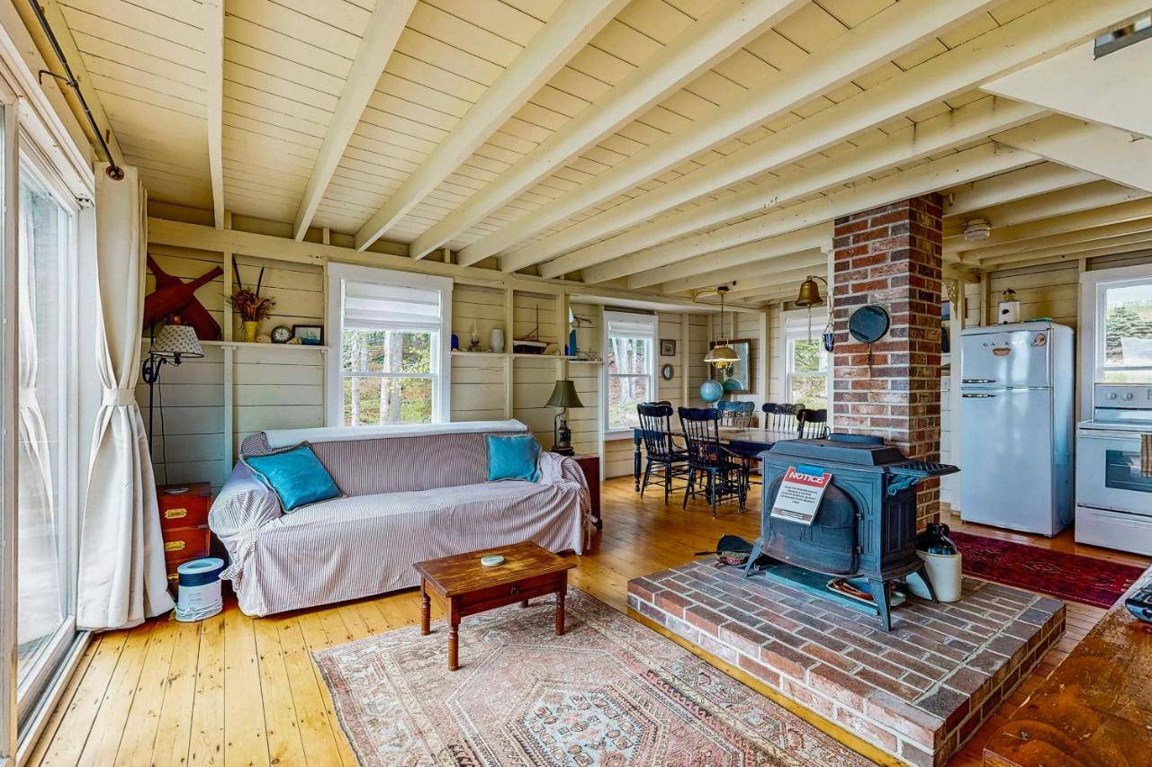 a living room with a couch and a stove at Boothbay Beauty in Boothbay Harbor