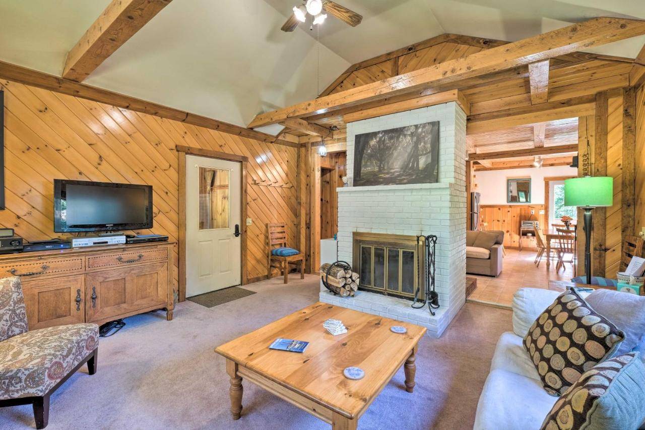 a living room with a couch and a fireplace at 1 Mi to Downtown BBH Coastal Cabin with Deck and Yard in Boothbay Harbor