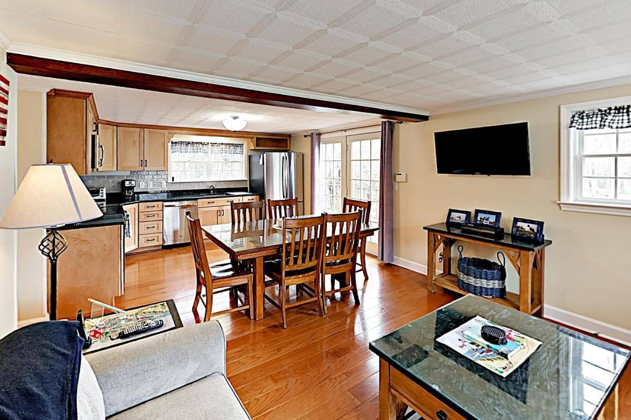 a kitchen and living room with a table and chairs at The Badger Den in Boothbay Harbor