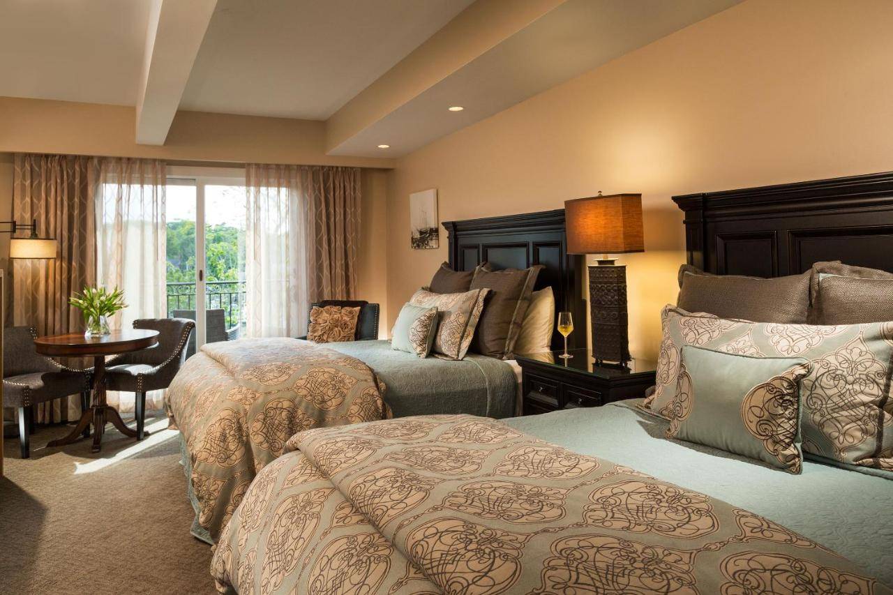 a hotel room with two beds and a table at 16 Bay View in Camden