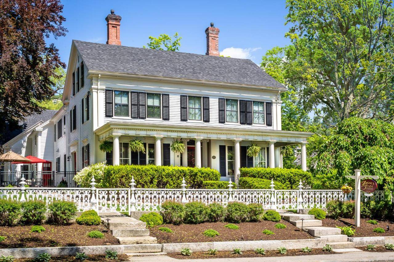 a white house with a white picket fence at Abigail's Inn in Camden