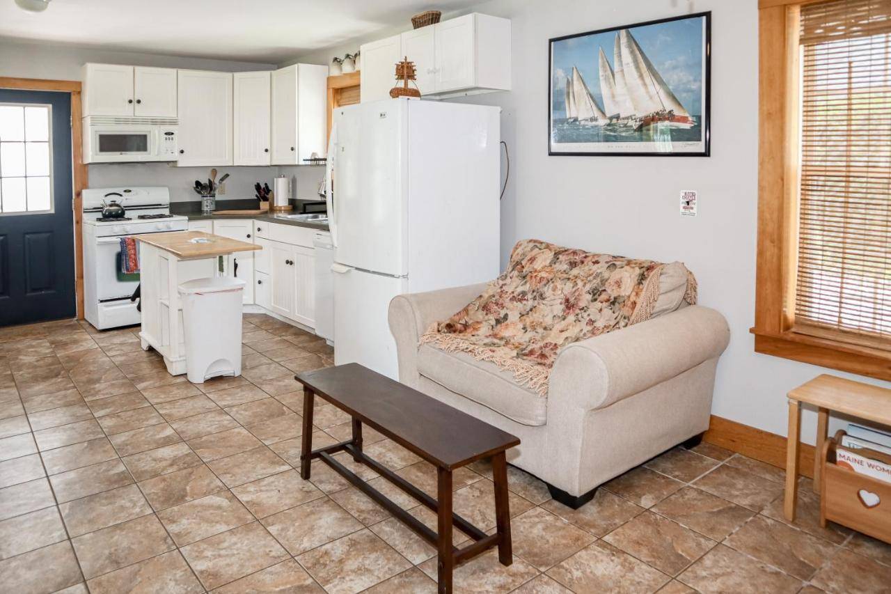 a living room with a couch and a kitchen at The Wheelhouse in Camden