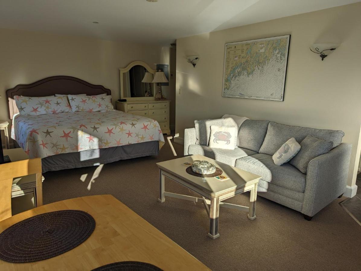 a living room with a bed and a couch and a table at Riverfront 2nd floor with balcony Sheepscot Harbour Vacation Club Studio #210 in Edgecomb