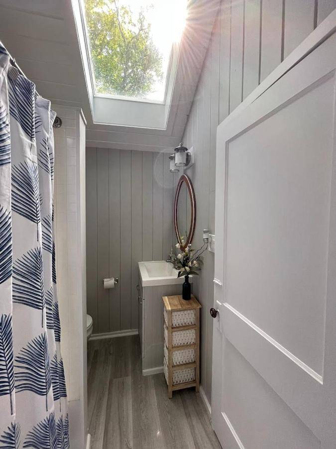 a bathroom with a skylight and a toilet and a window at Spacious 1 Bedroom Cottage Close to Everything 1 in Edgecomb