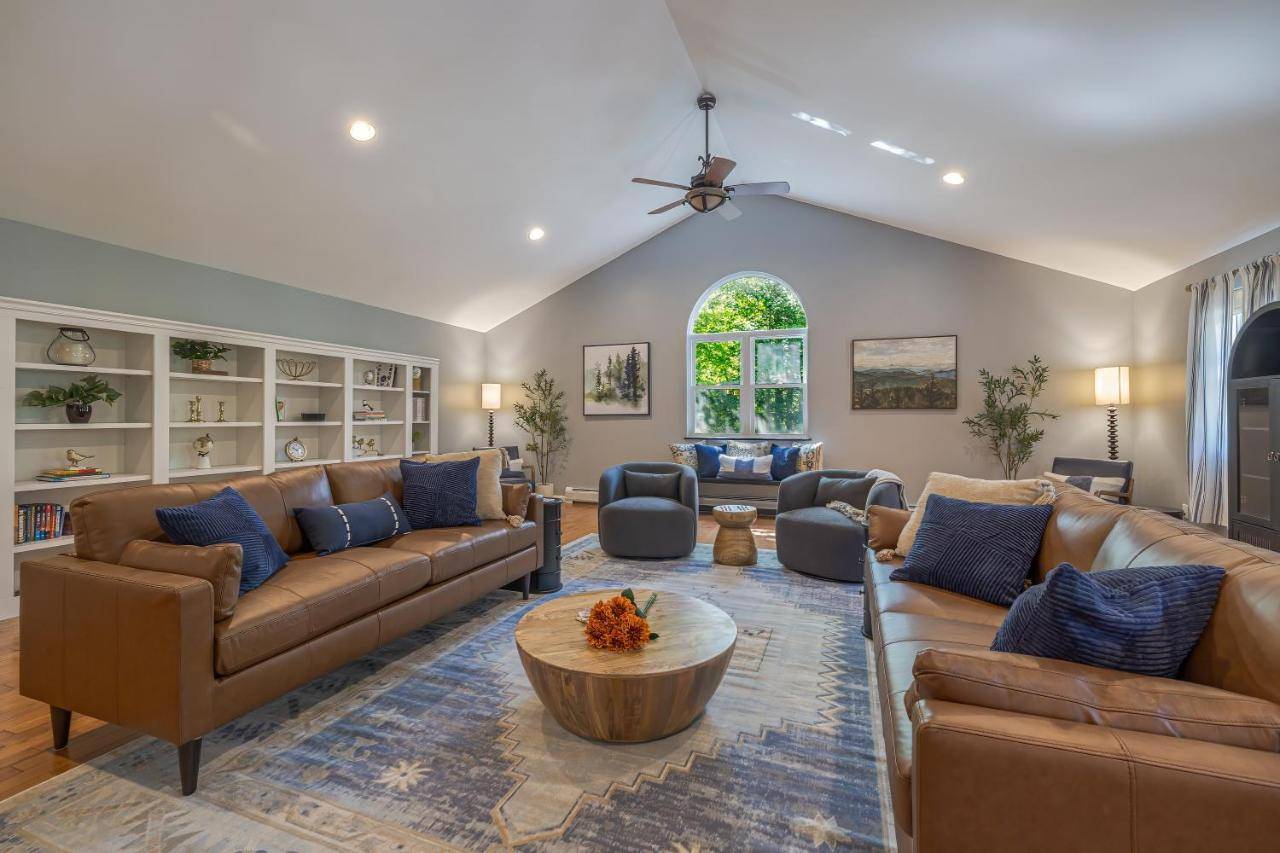 a large living room with couches and a table at 4BR Retreat, 16mi to Acadia NP, with Game Room in Ellsworth