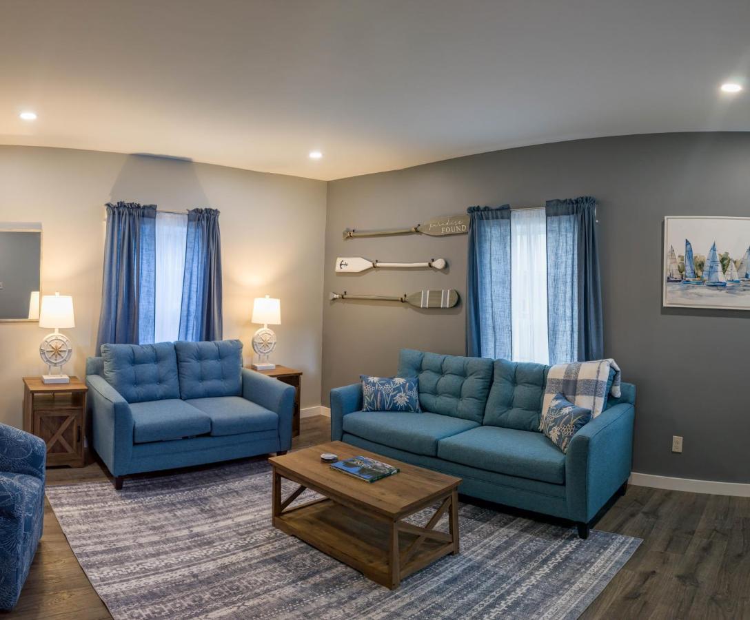 a living room with two blue couches and a table at Newly Renovated Acadia Apartment Mple Street in Ellsworth