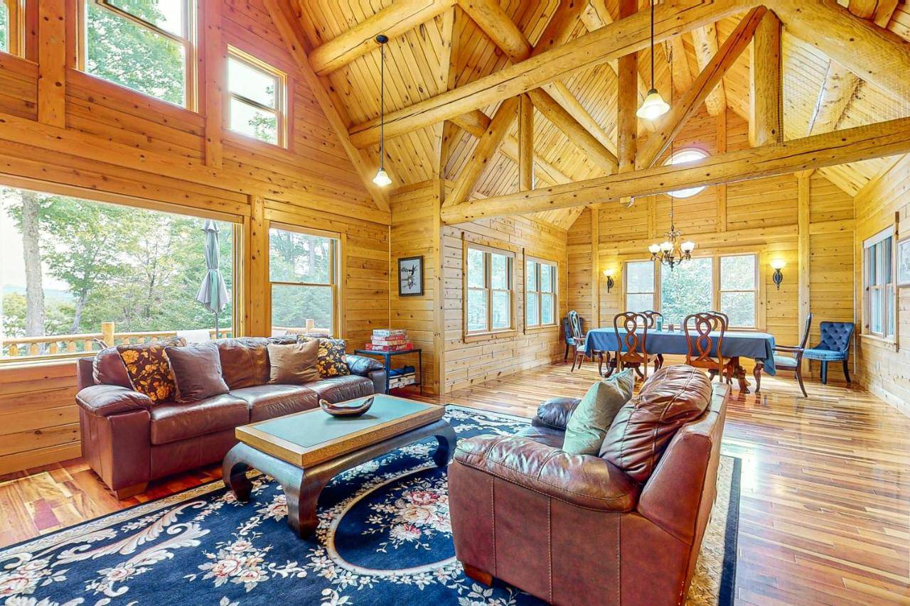 a living room with couches and a table in a cabin at Tranquil Haven in Greenville