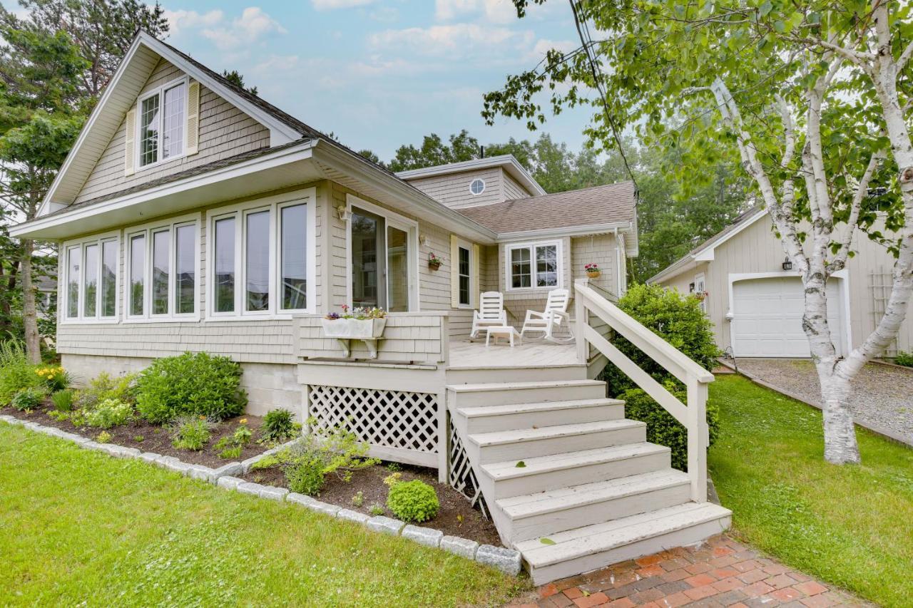 a small white house with a porch and stairs at Kennebunkport Getaway with Grill Walk to Beach! in Kennebunkport