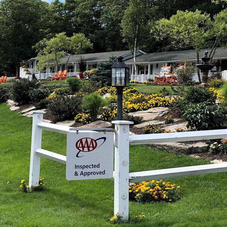 a white fence with a sign on it with aokedoked and approved sign at Delightful Room for Couples in a Bed and Breakfast near Camden, Maine in Lincolnville