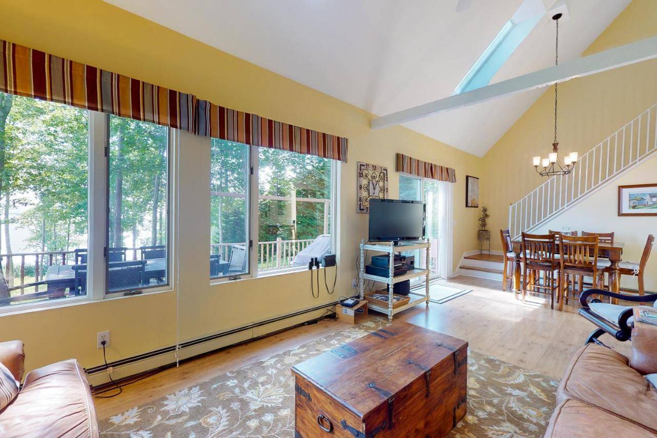 a living room with a couch and a table at A Sunrise at Seaview in Lincolnville