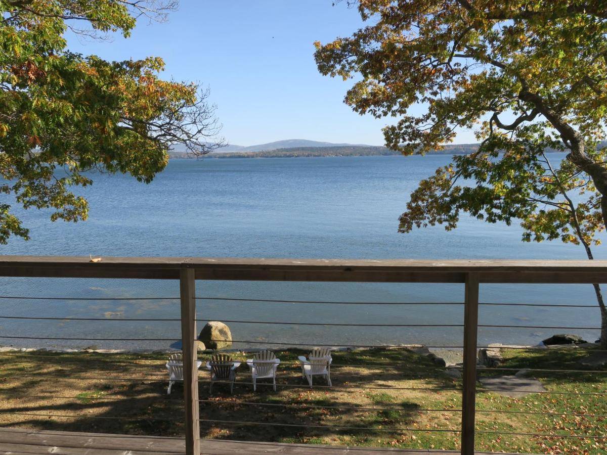 a view of a body of water with chairs at Acadia Ocean Front Garden Cottages in Trenton
