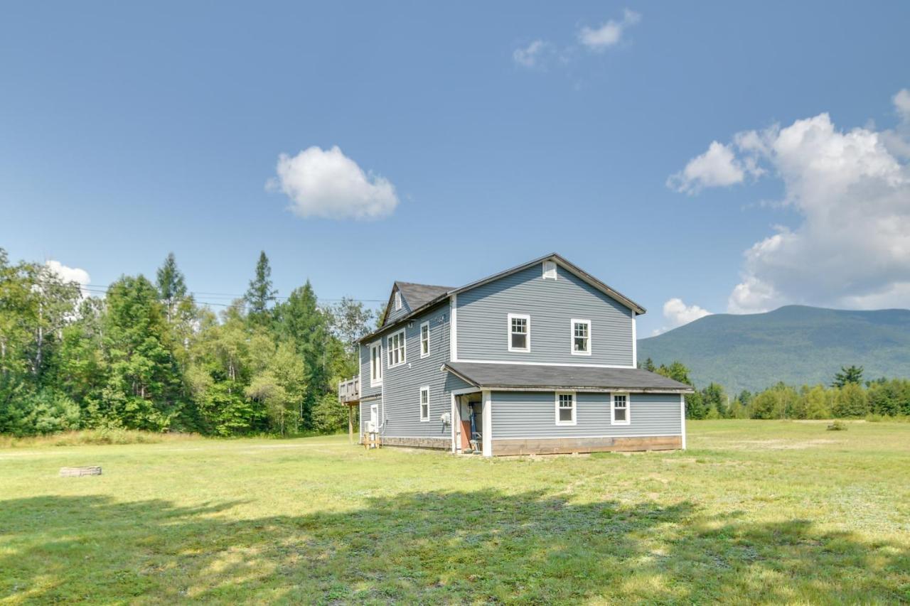 a gray house on a field with mountains in the background at Mountain-View Maine Cabin Ski, Hike and Bike! in New Portland