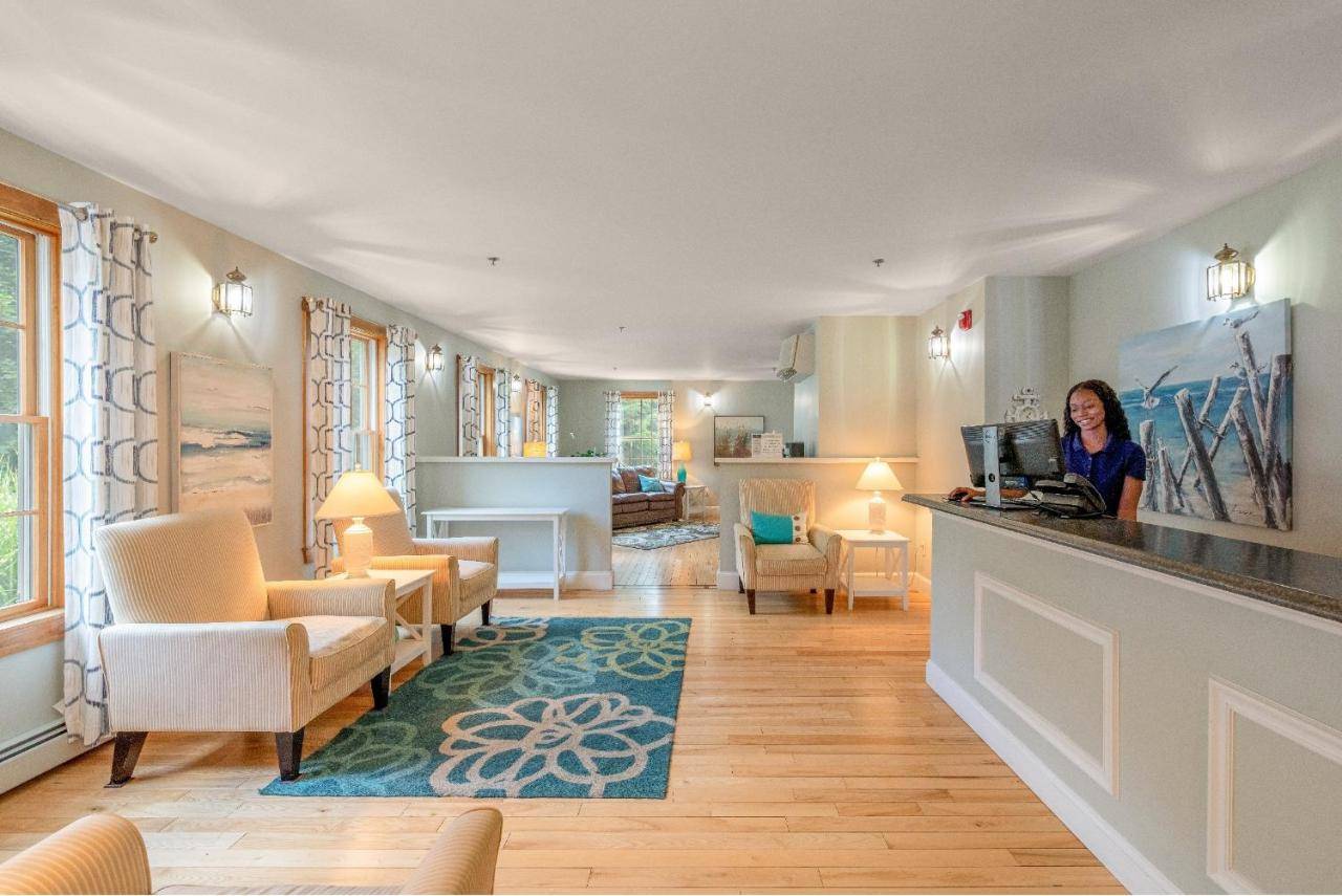 a woman standing at a counter in a room at Admiral's Inn Resort in Ogunquit