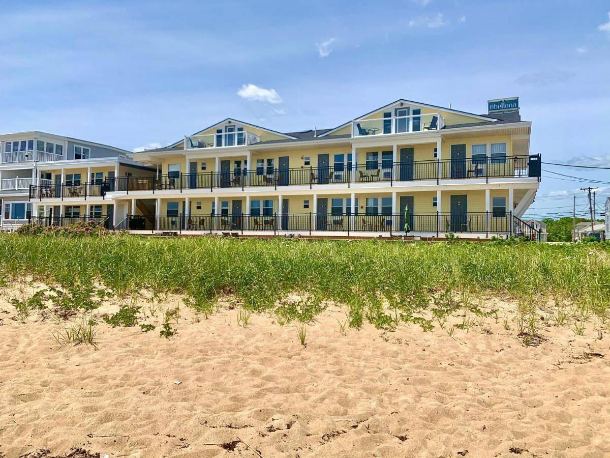 a large building on the beach next to the sand at Abellona Inn & Suites in Old Orchard Beach