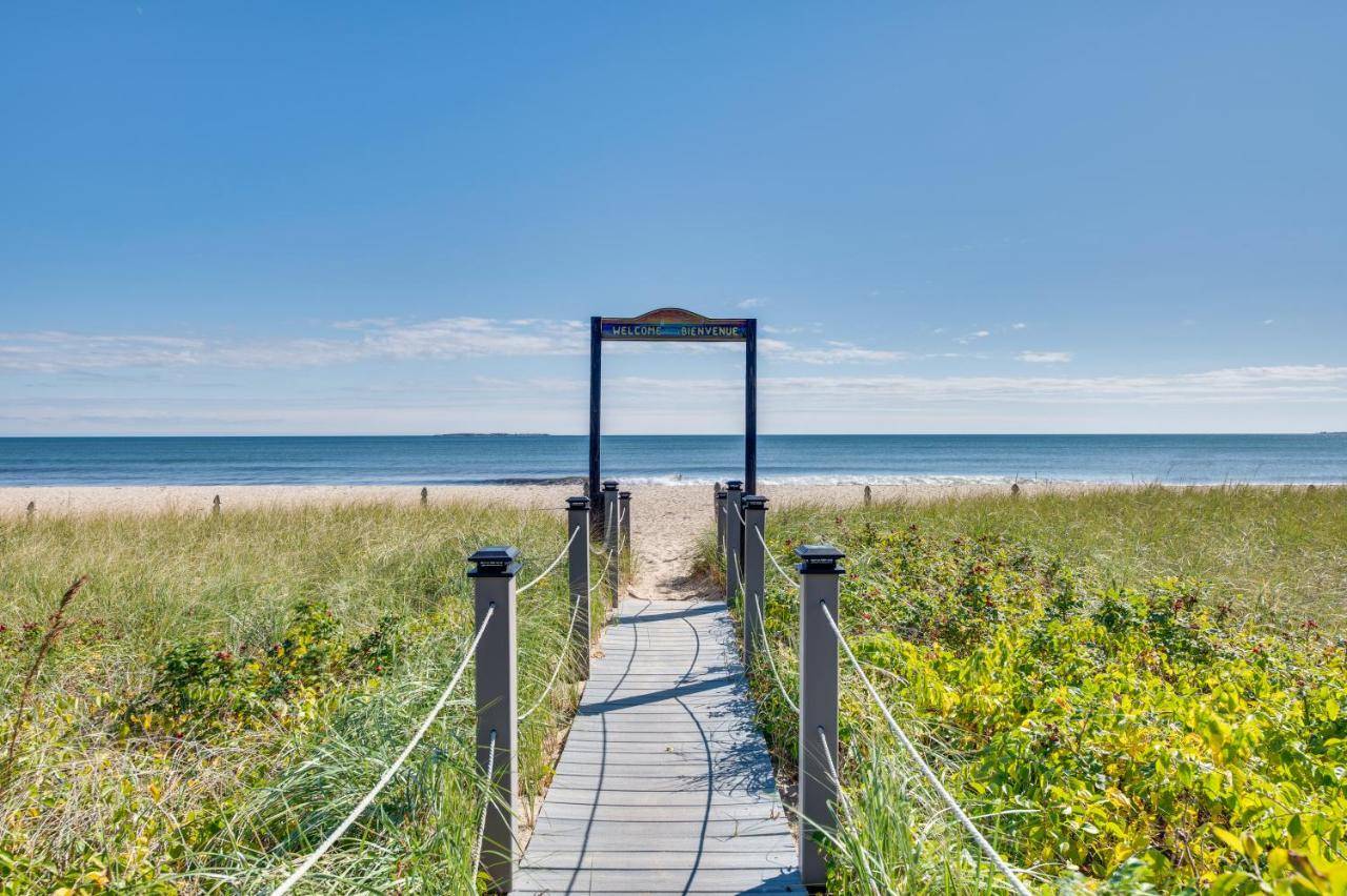 a wooden path to the beach with a sign on it at Beachfront 15 Condo on Old Orchard Beach in Old Orchard Beach