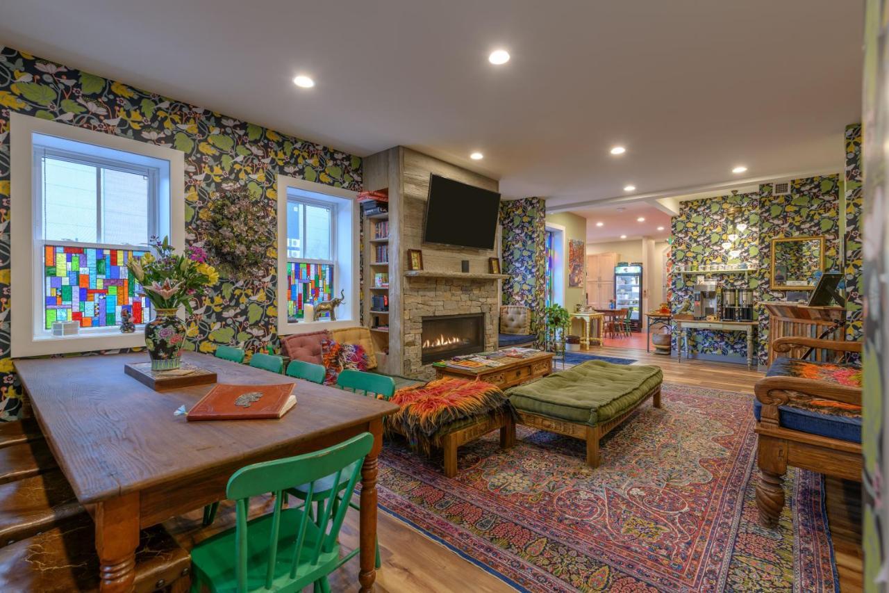 a living room with a table and a fireplace at Black Elephant Hostel in Portland