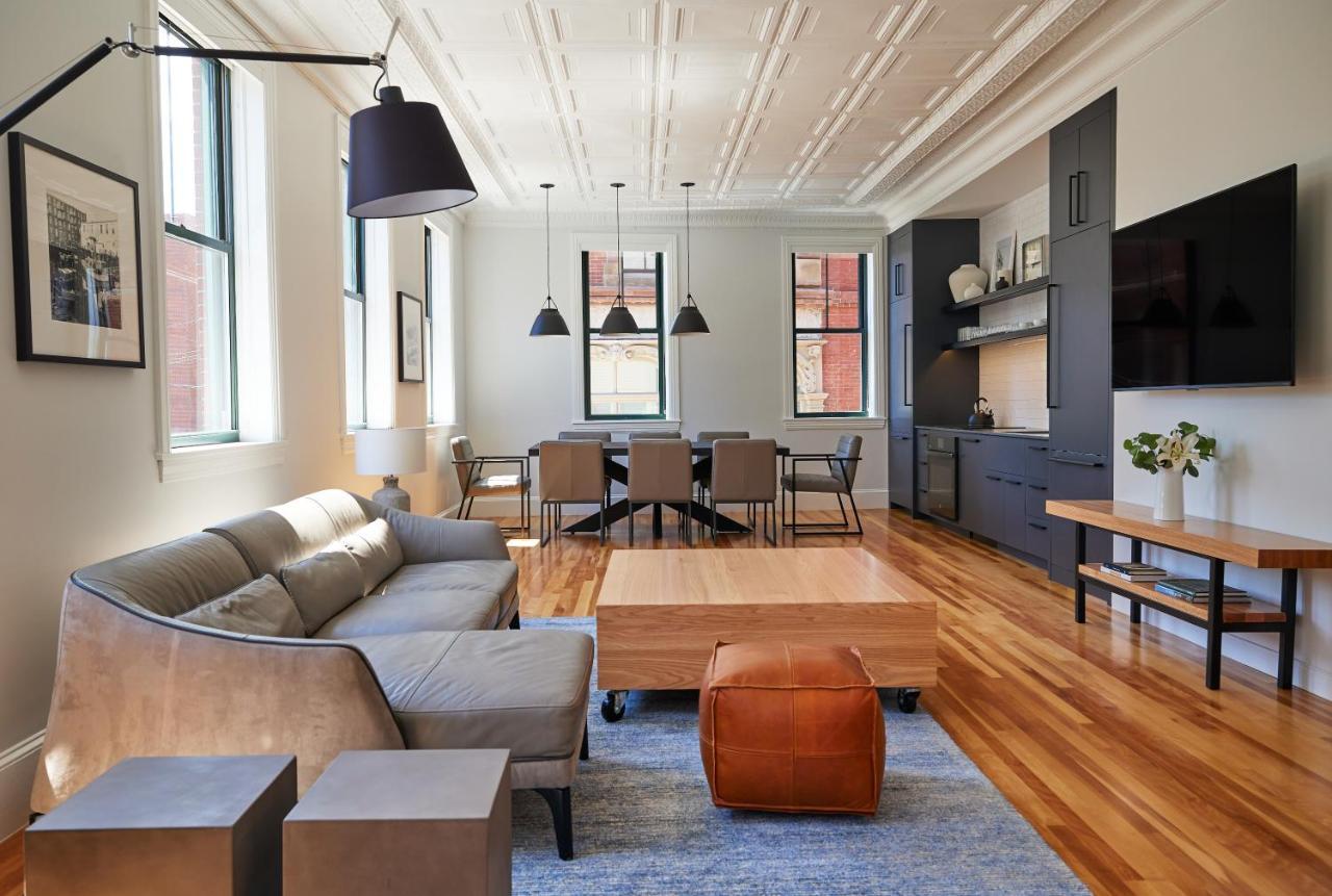 a living room with a couch and a table at The Docent's Collection in Portland