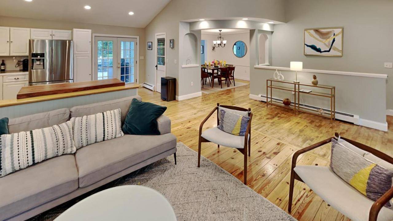 a living room with a couch and a kitchen at Saco Sanctuary in Saco