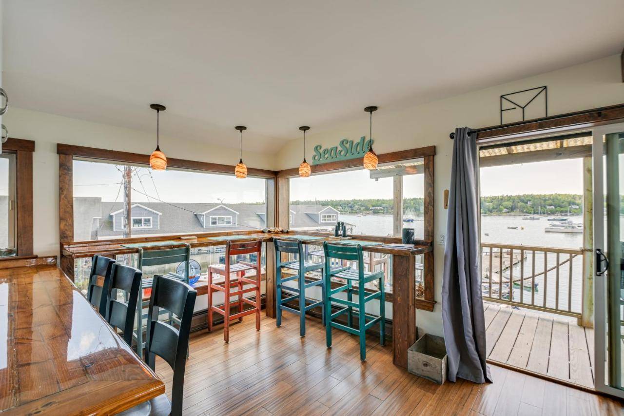 a room with a bar with a view of the water at Ocean-View Apt in the Heart of Southwest Harbor! in Southwest Harbor