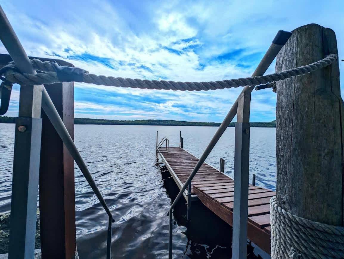 a dock on a body of water with a rope at Kayak Cabin on Flanders Pond NEW in Sullivan
