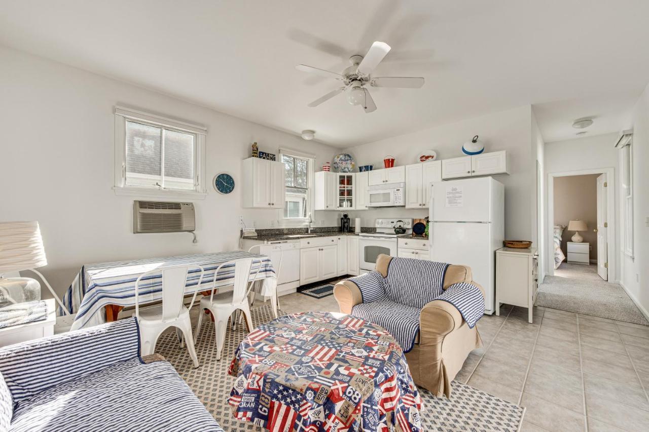 a kitchen with white cabinets and a table and chairs at Cozy Wells Cottage with Pool Access 1 Mi to Beach! in Wells
