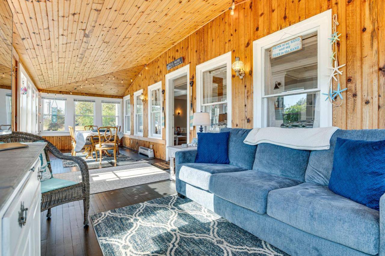 a living room with a blue couch and a table at Hot Tub and Fireplace Coastal Getaway in Maine in Wells