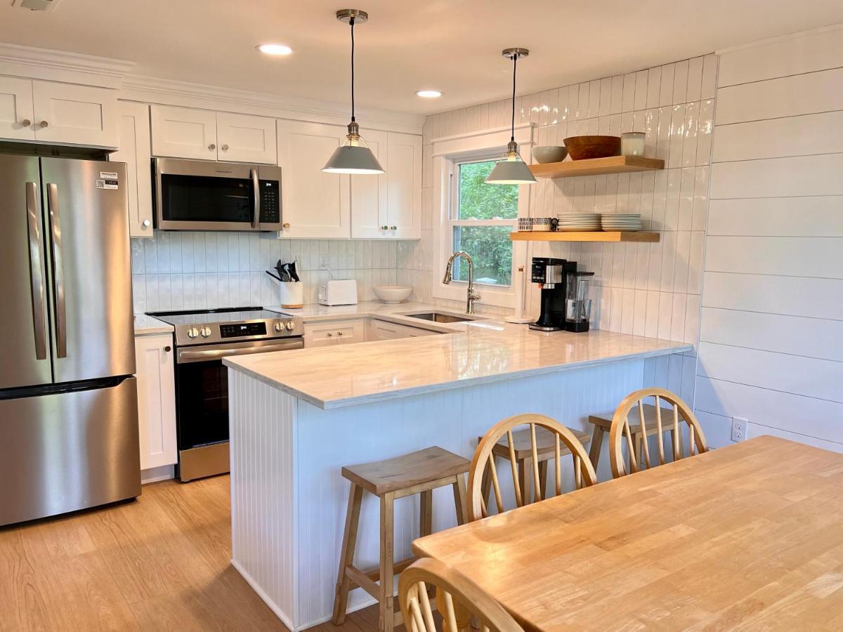 a kitchen with a refrigerator and a table with chairs at Sleeps 10, Approx 1 Mile to the Beach, Fully Renovated in 2025 in Wells