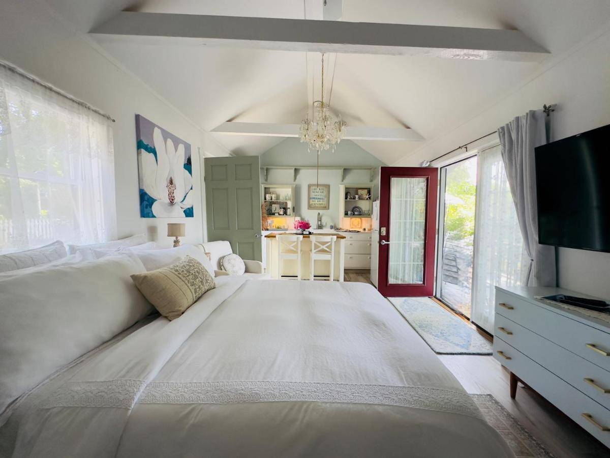 a large white bed in a room with a tv at Recharge at Tranquil Sea Salt Cottage in Historic Wiscasset in Wiscasset