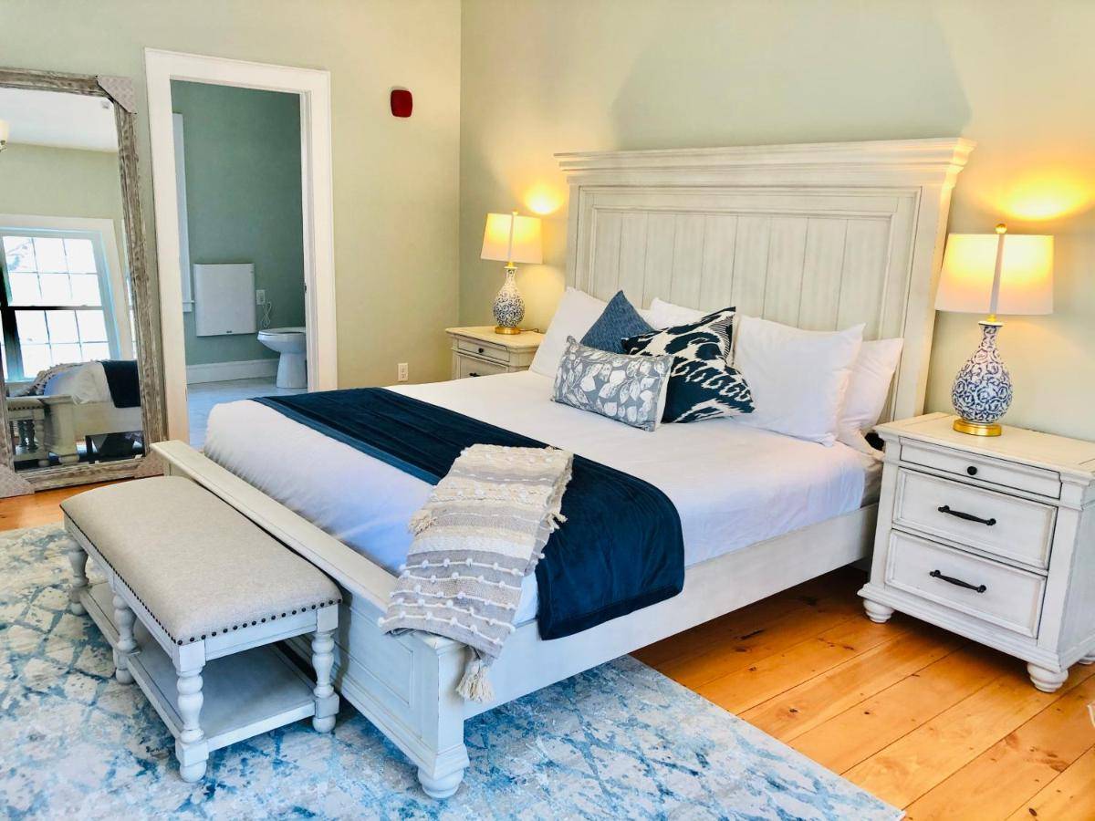 a bedroom with a large white bed and a mirror at Albracca in York