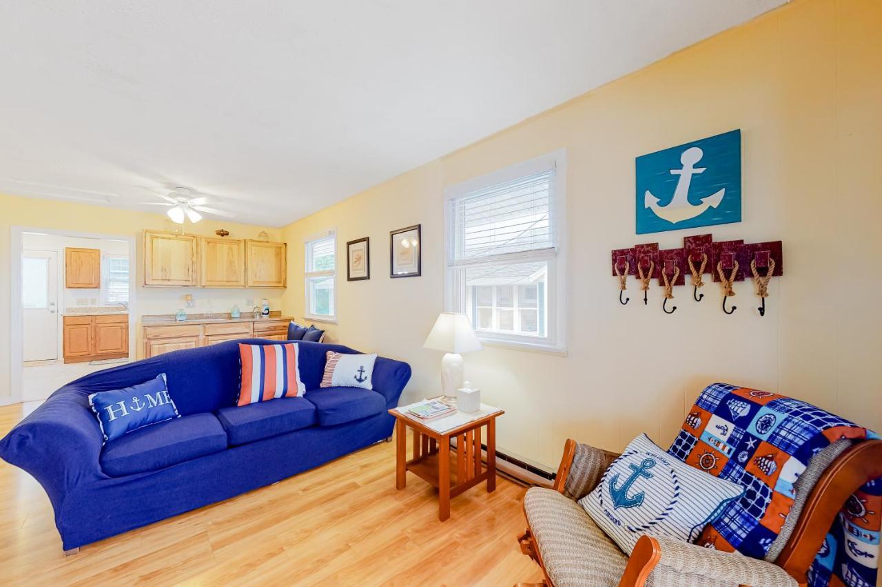 a living room with a blue couch and a table at Lil' Cottage Retreat in York