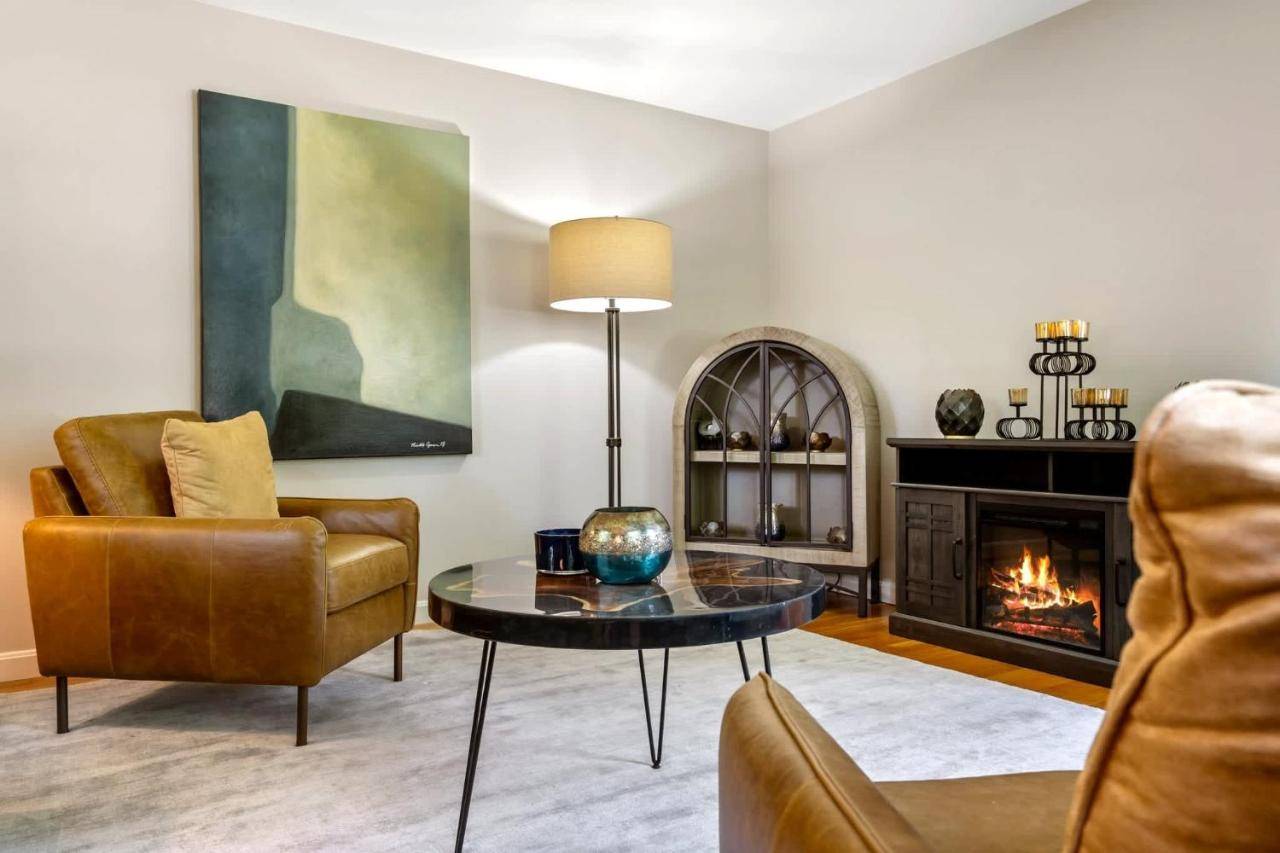 a living room with a table and a fireplace at Maine Adventure 3BR Oasis Awaits in York